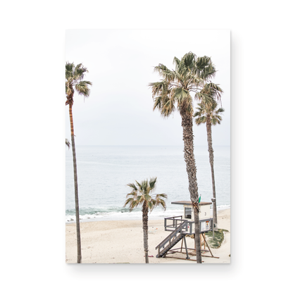 Vertical coastal photography of a coastal scene with palm trees and a lifeguard tower at Aliso Beach, Laguna California, with a wooden frame. Photograph in minimalist mock up.