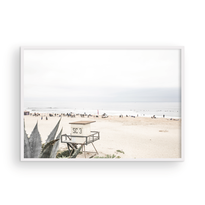 Landscape beach photography of Salt Creek Beach, with lifeguard tower SC 3 in the foreground, and many people enjoying the beach and ocean in the distance. A beach vibes print. Photograph in minimalist mock up.