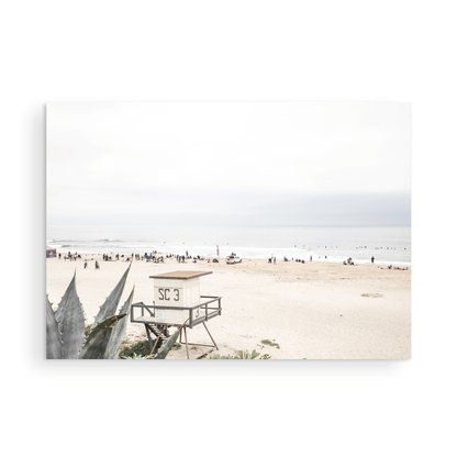 Landscape beach photography of Salt Creek Beach, with lifeguard tower SC 3 in the foreground, and many people enjoying the beach and ocean in the distance. A beach vibes print. Photograph in minimalist mock up.