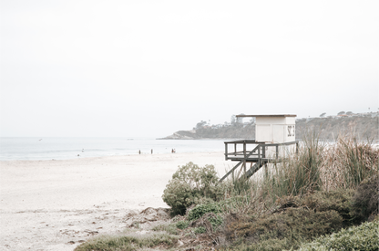 Landscape beach photography of Salt Creek Beach, with lifeguard tower SC 3 in the foreground, and many people enjoying the beach and ocean in the distance. A beach vibes print. Photograph in minimalist mock up.