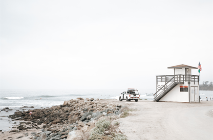 Landscape beach photography of Salt Creek Beach, with lifeguard tower SC 4 in the foreground, and many people enjoying the beach and ocean in the distance. A beach vibes print. 