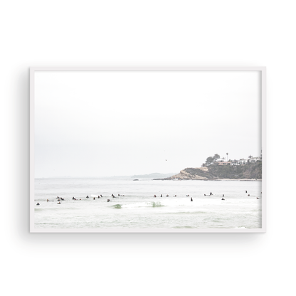 Landscape surf wall decor showing many surfers waiting for waves in the ocean at Salt Creek Beach, with a distant cliffside. This print captures the surf vibes of Southern California. Photograph in minimalist mock up.