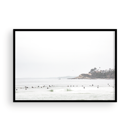 Landscape surf wall decor showing many surfers waiting for waves in the ocean at Salt Creek Beach, with a distant cliffside. This print captures the surf vibes of Southern California. Photograph in minimalist mock up.