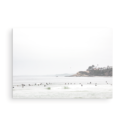 Landscape surf wall decor showing many surfers waiting for waves in the ocean at Salt Creek Beach, with a distant cliffside. This print captures the surf vibes of Southern California. Photograph in minimalist mock up.