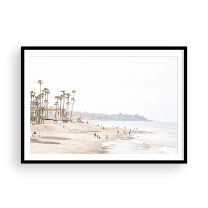 Landscape coastal photography of a wide sandy beach at San Clemente State Beach, with tall palm trees and people enjoying the calm ocean. Perfect for a beach theme wall decor. Photograph in minimalist mock up.