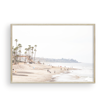 Landscape coastal photography of a wide sandy beach at San Clemente State Beach, with tall palm trees and people enjoying the calm ocean. Perfect for a beach theme wall decor. Photograph in minimalist mock up.