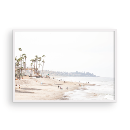 Landscape coastal photography of a wide sandy beach at San Clemente State Beach, with tall palm trees and people enjoying the calm ocean. Perfect for a beach theme wall decor. Photograph in minimalist mock up.