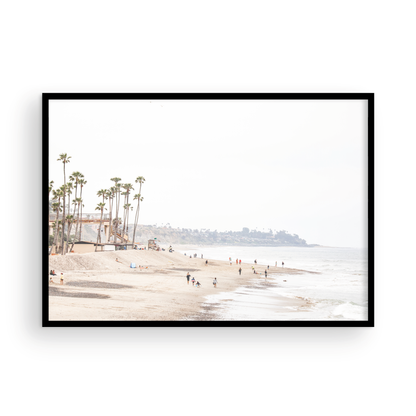 Landscape coastal photography of a wide sandy beach at San Clemente State Beach, with tall palm trees and people enjoying the calm ocean. Perfect for a beach theme wall decor. Photograph in minimalist mock up.