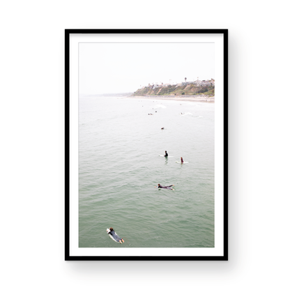 Vertical surf print of surfers floating in the ocean waves at a Southern California beach, with a distant coastline. This image captures surfing art and a minimalist surf vibe. Photograph in minimalist mock up.