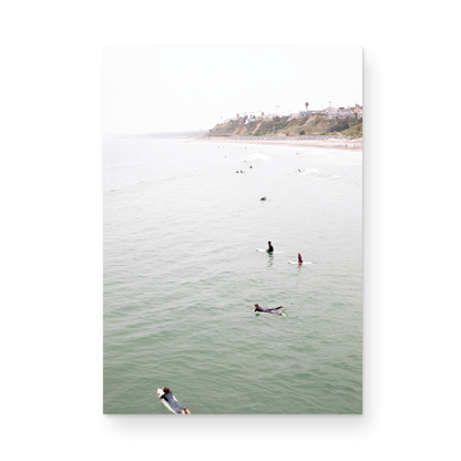Vertical surf print of surfers floating in the ocean waves at a Southern California beach, with a distant coastline. This image captures surfing art and a minimalist surf vibe. Photograph in minimalist mock up.