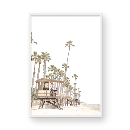 A landscape coastal photography view of San Clemente State Beach in Southern California, featuring a row of tall palm trees, a lifeguard tower, and people enjoying the calm beach. This vertical image evokes Summer Vibes Wall Art and tropical beach print aesthetics. Photograph in minimalist mock up.