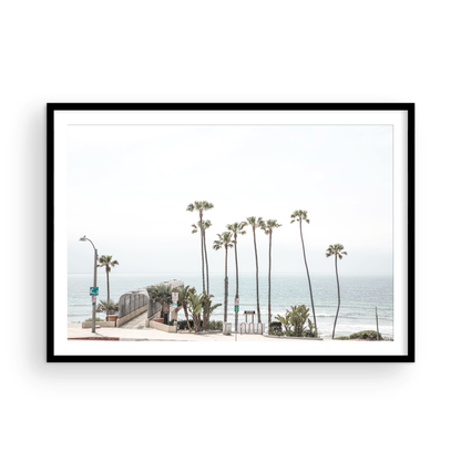 Landscape coastal photography of T-Street Beach in San Clemente, with tall palm trees and a unique pier structure leading to the ocean. A perfect horizontal California coast print. Photograph in minimalist mock up