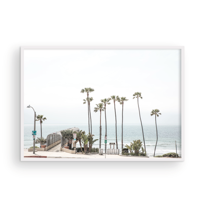 Landscape coastal photography of T-Street Beach in San Clemente, with tall palm trees and a unique pier structure leading to the ocean. A perfect horizontal California coast print. Photograph in minimalist mock up
