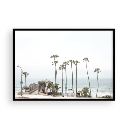 Landscape coastal photography of T-Street Beach in San Clemente, with tall palm trees and a unique pier structure leading to the ocean. A perfect horizontal California coast print. Photograph in minimalist mock up