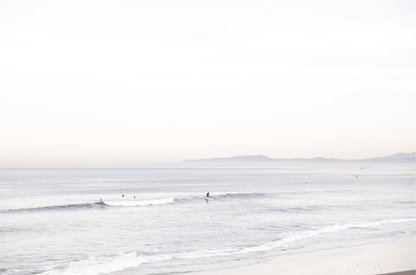 Horizontal minimalist ocean print showing a smooth seascape with gentle ocean waves meeting a clear horizon line. This calm ocean print provides a serene view. 