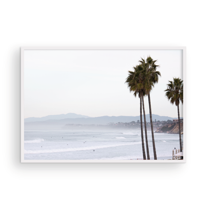 Landscape San Diego beach print showing a seascape with gentle ocean waves in the water and palm trees in the foreground. Photograph in minimalist mock up.