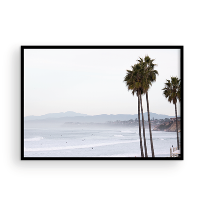 Landscape San Diego beach print showing a seascape with gentle ocean waves in the water and palm trees in the foreground. Photograph in minimalist mock up.