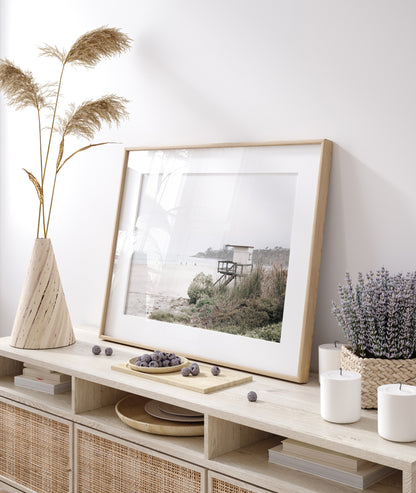 Landscape beach photography of Salt Creek Beach, with lifeguard tower SC 3 in the foreground, and many people enjoying the beach and ocean in the distance. A beach vibes print. Photograph in minimalist mock up.