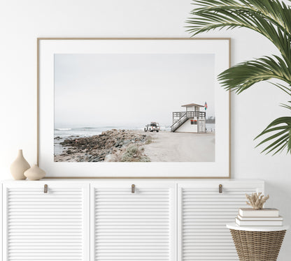 Landscape beach photography of Salt Creek Beach, with lifeguard tower SC 4 in the foreground, and many people enjoying the beach and ocean in the distance. A beach vibes print. Photograph in minimalist mock up.