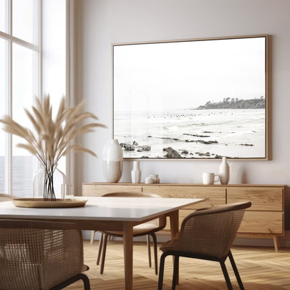 Landscape coastal photography of Salt Creek Beach with dark rocks on the shore and numerous surfers in the ocean. A neutral ocean print perfect for beach house decor. Photograph in minimalist mock up.