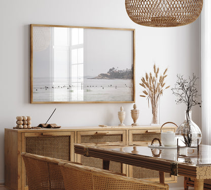 Landscape surf wall decor showing many surfers waiting for waves in the ocean at Salt Creek Beach, with a distant cliffside. This print captures the surf vibes of Southern California. Photograph in minimalist mock up.