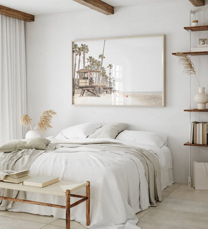 A wide landscape coastal photography view of San Clemente State Beach in Southern California, featuring a row of tall palm trees, a lifeguard tower, and people enjoying the calm beach. This image evokes Summer Vibes Wall Art and tropical beach print aesthetics. Photograph in minimalist mock up.