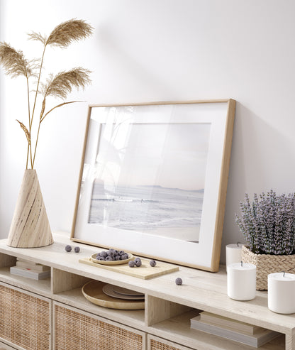 Horizontal minimalist ocean print showing a smooth seascape with gentle ocean waves meeting a clear horizon line. This calm ocean print provides a serene view. Photograph in minimalist mock up.