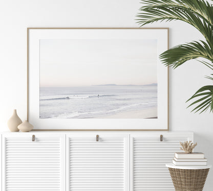 Horizontal minimalist ocean print showing a smooth seascape with gentle ocean waves meeting a clear horizon line. This calm ocean print provides a serene view. Photograph in minimalist mock up.
