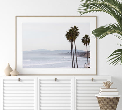 Landscape San Diego beach print showing a seascape with gentle ocean waves in the water and palm trees in the foreground. Photograph in minimalist mock up.