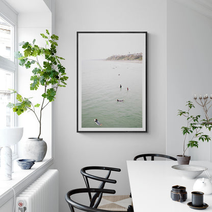 Vertical surf print of surfers floating in the ocean waves at a Southern California beach, with a distant coastline. This image captures surfing art and a minimalist surf vibe. Photograph in minimalist mock up.