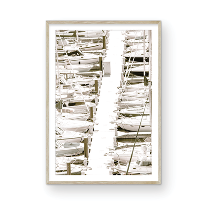 Vertical nautical wall print featuring a marina packed with white boats docked at the San Diego harbor. Photograph in minimalist mock up.