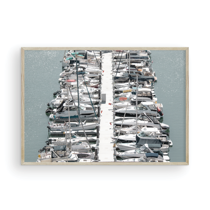 Horizontal nautical wall print featuring a marina packed with white boats docked at the San Diego harbor. Photograph in minimalist mock up.