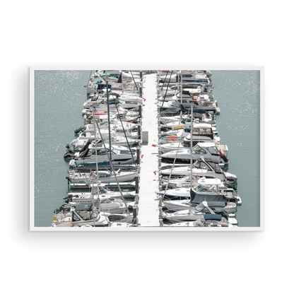 Horizontal nautical wall print featuring a marina packed with white boats docked at the San Diego harbor. Photograph in minimalist mock up.