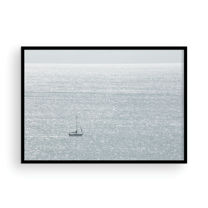 Large minimalist ocean print showing a smooth seascape with gentle ocean waves meeting a clear horizon line, one single sail boat in the distance. This calm nautical print provides a serene view in Dana Point, San Diego, California. Photograph in minimalist mock up.