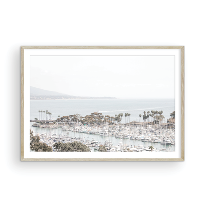 Horizontal nautical wall print featuring a marina with boats and palm trees on a foggy day, white boats docked at the San Diego harbor. Photograph in minimalist mock up.