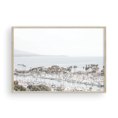 Horizontal nautical wall print featuring a marina with boats and palm trees on a foggy day, white boats docked at the San Diego harbor. Photograph in minimalist mock up.