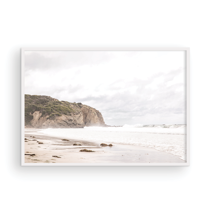 Minimalist ocean print of ocean waves and large sandy cliffs in the distance overlooking the seascape. Photograph in minimalist mock up.