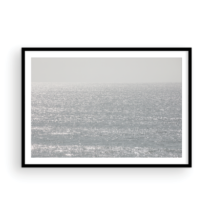Minimalist ocean art print of a bright, sunlit ocean surface, creating a sparkling seascape. This calm ocean print is perfect for modern coastal decor. Photograph in minimalist mock up.