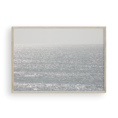 Minimalist ocean art print of a bright, sunlit ocean surface, creating a sparkling seascape. This calm ocean print is perfect for modern coastal decor. Photograph in minimalist mock up.
