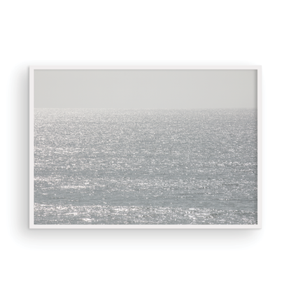 Minimalist ocean art print of a bright, sunlit ocean surface, creating a sparkling seascape. This calm ocean print is perfect for modern coastal decor. Photograph in minimalist mock up.