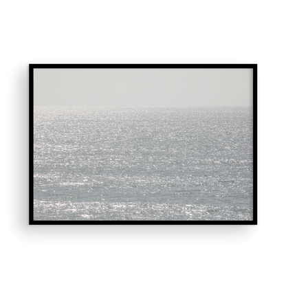 Minimalist ocean art print of a bright, sunlit ocean surface, creating a sparkling seascape. This calm ocean print is perfect for modern coastal decor. Photograph in minimalist mock up.