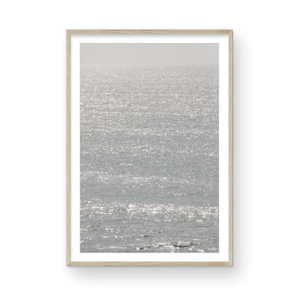 Minimalist ocean art print of a bright, sunlit ocean surface, creating a sparkling vertical seascape. Photograph in minimalist mock up.