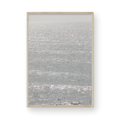 Minimalist ocean art print of a bright, sunlit ocean surface, creating a sparkling vertical seascape. Photograph in minimalist mock up.