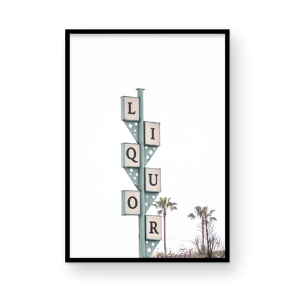 A vertical shot of the iconic Leucadia Liquor sign, with each letter of "LIQUOR" in a separate box against a teal-colored post and a bright white sky with palm trees in the background. Photograph in minimalist mock up