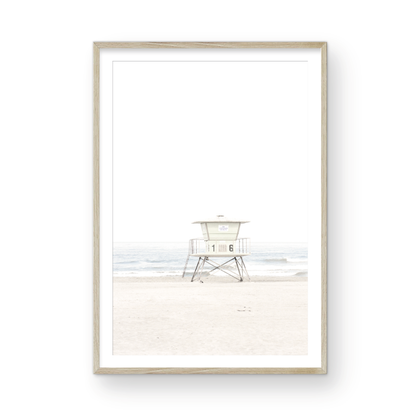A vertical beach art close-up of a pale lifeguard tower (16), with ocean waves in the distance, on a San Diego Beach. Photograph in minimalist mock up.