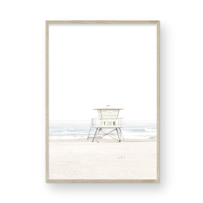 A vertical beach art close-up of a pale lifeguard tower (16), with ocean waves in the distance, on a San Diego Beach. Photograph in minimalist mock up.