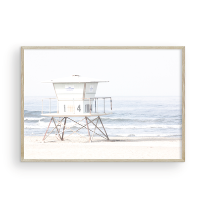 A horizontal beach art close-up of a pale lifeguard tower (14), with ocean waves in the distance, on a San Diego Beach. Photograph in minimalist mock up.