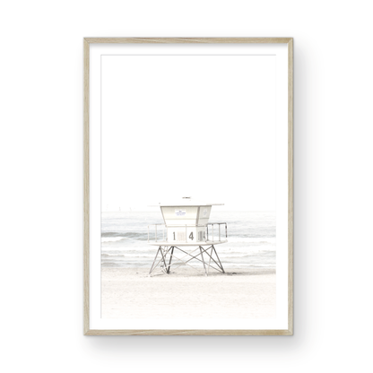 A vertical beach art close-up of a pale lifeguard tower (14), with ocean waves in the distance, on a San Diego Beach. Photograph in minimalist mock up.