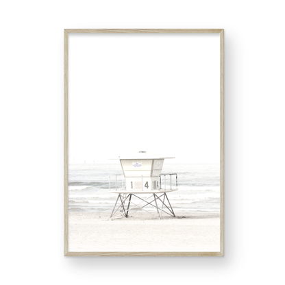 A vertical beach art close-up of a pale lifeguard tower (14), with ocean waves in the distance, on a San Diego Beach. Photograph in minimalist mock up.