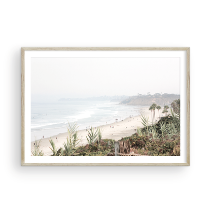 Landscape San Diego beach print showing seascape with gentle ocean waves in the water near a sandy cliff. Photograph in minimalist mock up.